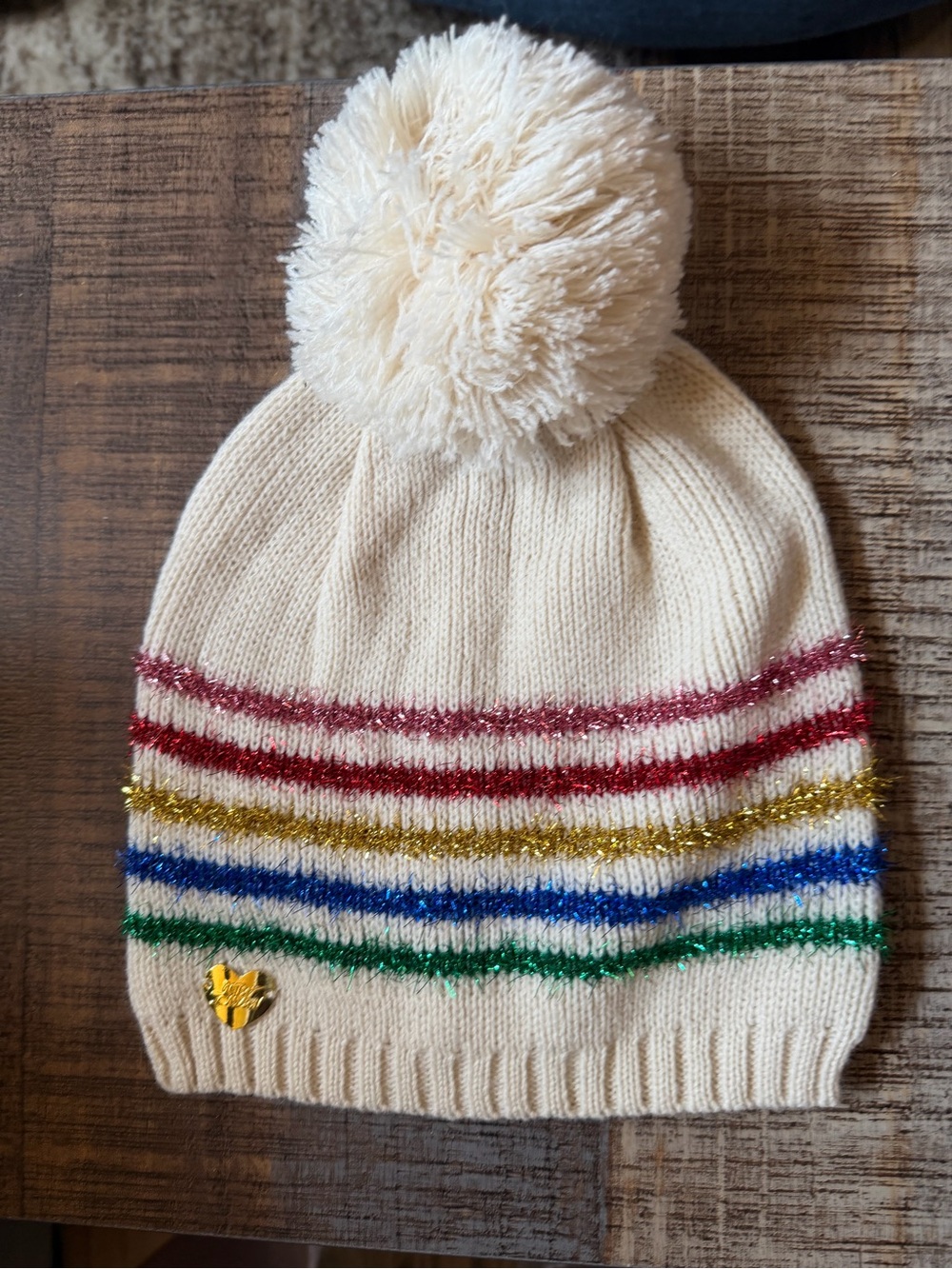 Betsey Johnson Cream Pom-Pom Beanie with Rainbow Metallic Stripes